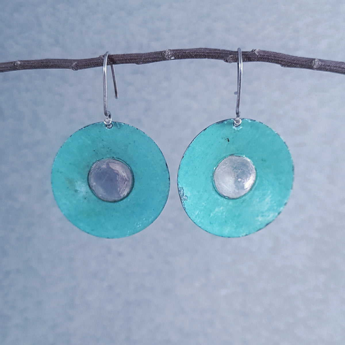 D1/10034  Silver and copper earring with patina.